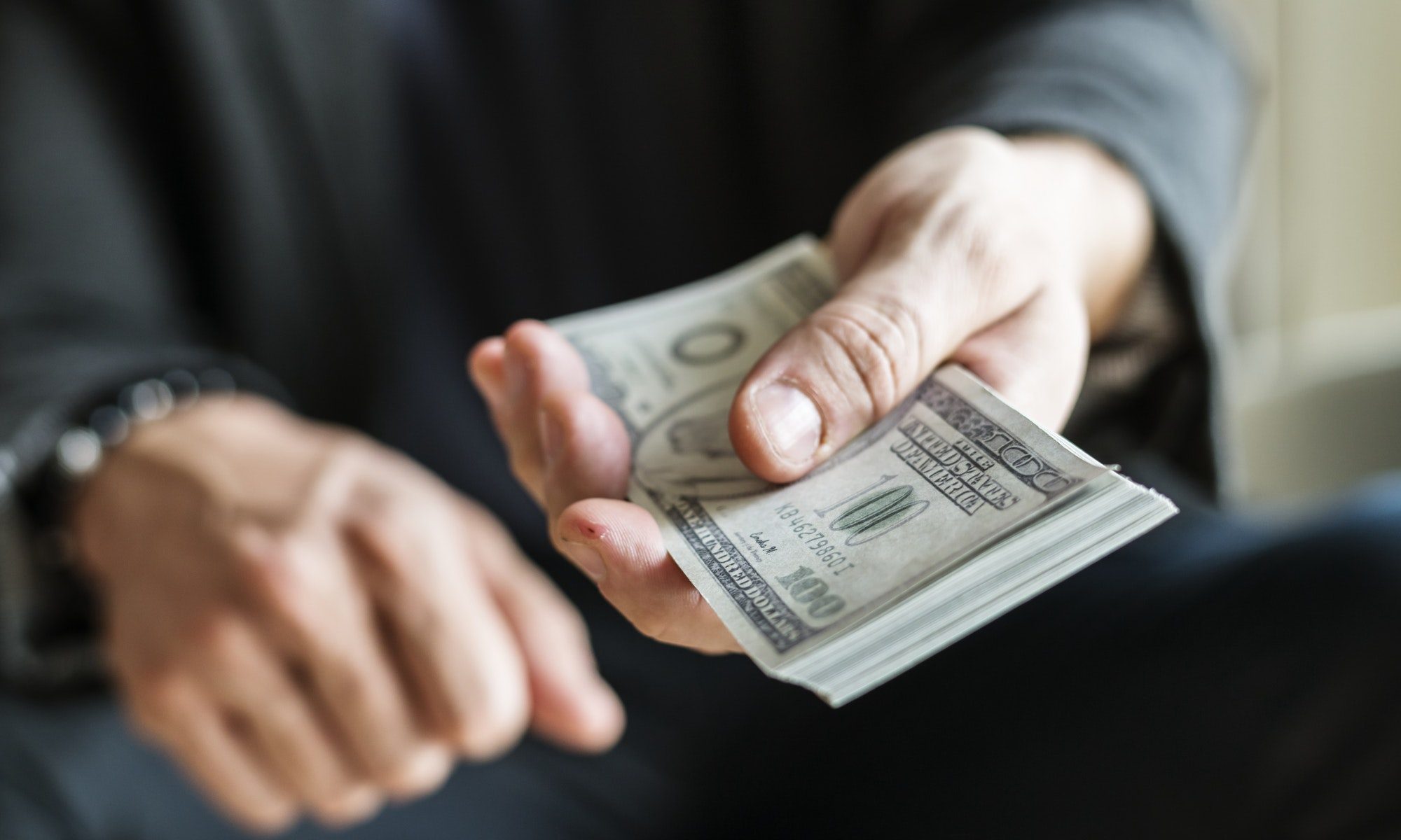 Closeup of hands holding cash